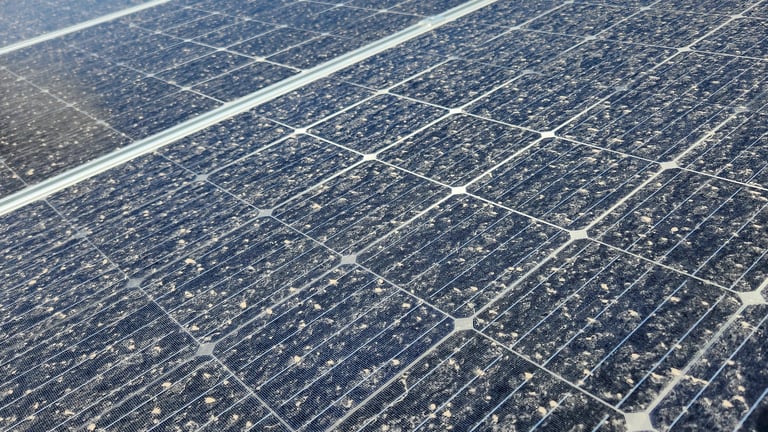 Dirty solar panels covered in dust and debris